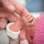premature-newborn-baby-holding-on-to-her-grandfathers-hand-her-hand-is-so-small-and-tiny-compared-181650388-16x9_1